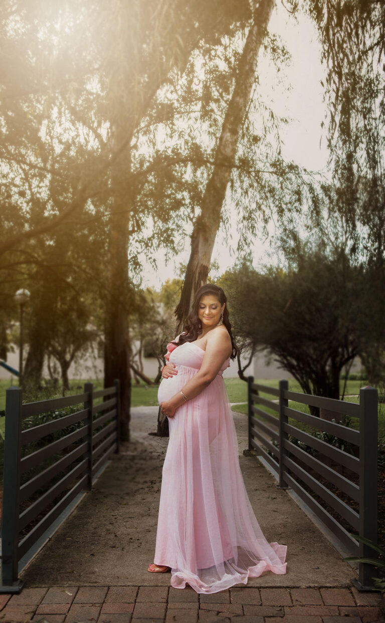 Pregnant woman in pink gown during outdoor maternity photoshoot near me in Midrand by top rated maternity photographer near me.